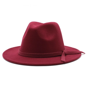 Close-up of a burgundy wool fedora hat with flat brim and matching ribbon band