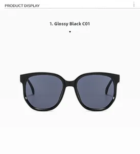 Vue détaillée de face de lunettes de soleil noires oversize avec charnières en métal