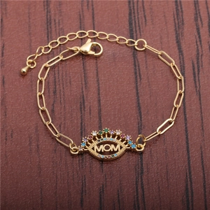 Golden MOM cuban chain bracelet for men featuring colorful rhinestones on a wood background