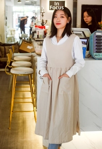Close-up of cotton apron featuring deep functional side pockets and minimalist textures
