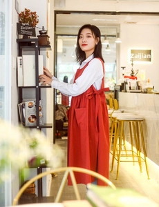 Red cotton apron on model in cafe setting, stylish full-coverage workwear for florists