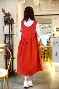 Detail view of the red cotton linen apron back design with U-neck and side tie straps