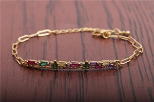 Macro shot of Cuban link chain featuring colorful rectangular zircons and lobster clasp