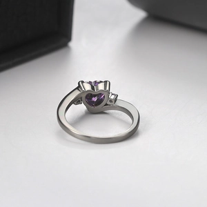 Elegant silver ring featuring a heart-shaped purple zircon stone in a claw setting