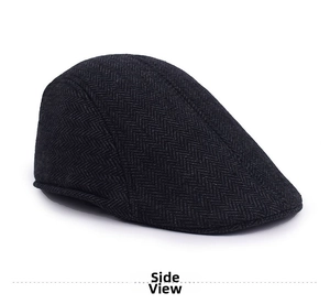 Detailed side view of dark grey herringbone texture on a classic wool newsboy cap