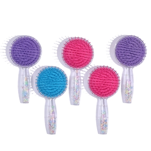 Close-up of colorful round hairbrushes with transparent handles and decorative beads