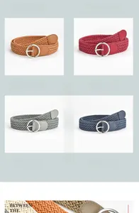 Detail of woven elastic belts in various colors featuring round silver metal buckles
