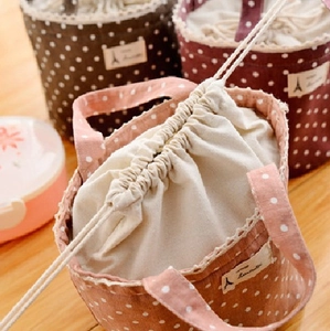 Polka dot canvas lunch bags with lace trim and Eiffel Tower labels in three colors