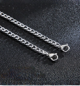 Macro view of stainless steel curb chain with dual lobster clasps and anti-rust finish