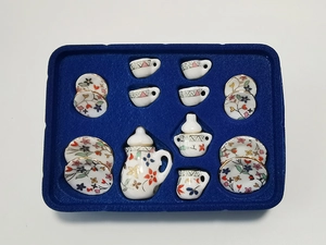 Miniature 1:12 dollhouse ceramic tea set with floral patterns in blue velvet tray display