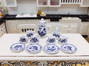Detailed view of a 15-piece miniature blue and white floral ceramic tea set for dollhouses