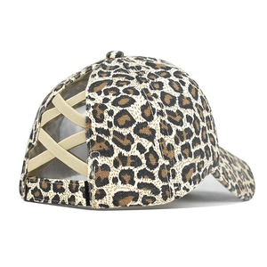 Detail showing leopard print ponytail baseball cap with elastic criss-cross back straps