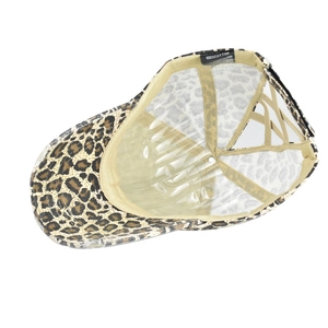 Detail of leopard print ponytail baseball cap showing 100% cotton label and inner lining