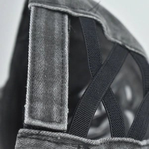 Detail of washed grey ponytail baseball cap with elastic criss-cross bands and velcro strap