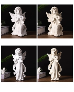 Detail showcasing Nordic prayer angel statues in various sizes and finishes on a desk