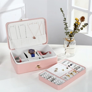 Pink velvet jewelry box detail showing necklace hooks and removable inner storage tray