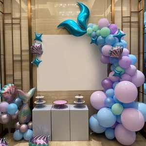 Detail of mermaid party balloon kit with purple mint balloons and fishtail foil decor