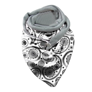 Detail of black and white paisley neck gaiter with soft grey fleece lining