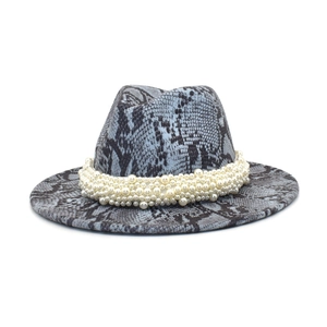 Detail of snake skin print fedora hat featuring multiple rows of white pearl embellishments