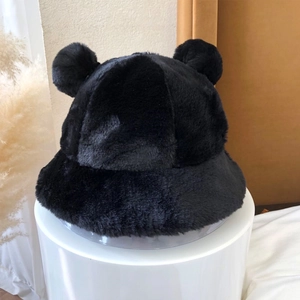 Detailed view of plush black faux fur bucket hat featuring cute teddy bear ears on top