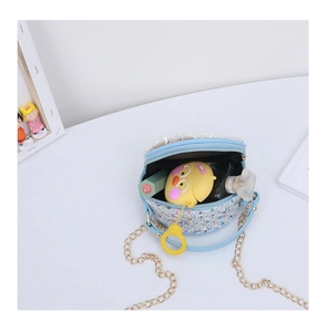 Detailed interior view of a blue tweed crossbody bag with sequins and chain strap