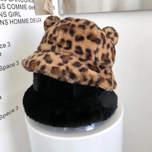 Detail of plush bucket hats with cute ears in leopard print and solid black