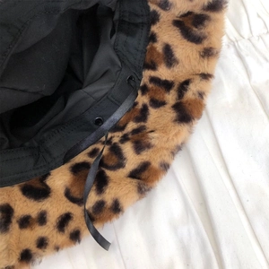 Detail of leopard faux fur bucket hat featuring an adjustable inner strap and cotton lining