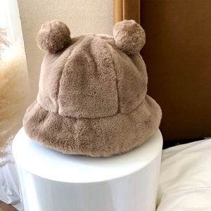 Detail of soft khaki plush bucket hat with cute animal ears on a white display stand