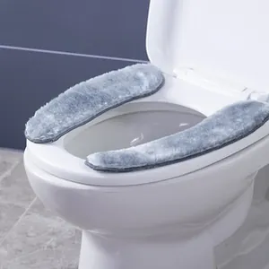 Detailed view of two-piece grey plush toilet seat cover installed in a modern bathroom