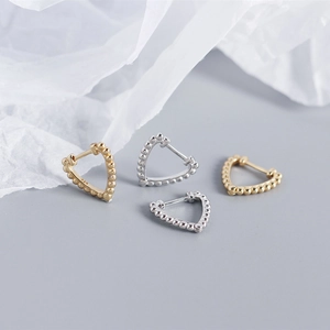 Detailed view of S925 sterling silver heart earrings with beaded texture in gold and silver