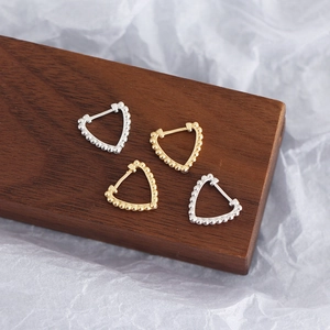 Detail of S925 sterling silver heart earrings with beaded edges in gold and silver finish
