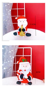 Close-up of 6cm Santa Claus cake toppers with candy cane and tree for holiday party