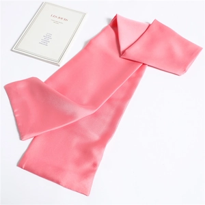 Detailed view of long pink satin skinny scarf showing smooth silk texture and soft folds