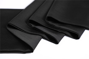 Detailed close-up showing the smooth texture and satin luster of a black silk neck scarf