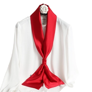 Elegant solid red narrow silk scarf tied on a white shirt collar for autumn styling