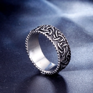 Detail shot showing the intricate Celtic knot relief on the silver stainless steel ring band