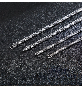 Close-up of four different thicknesses of stainless steel snake and basket chain necklaces