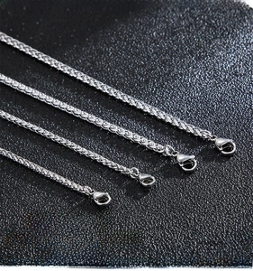 Detail of durable wheat chain necklace with secure lobster clasp on leather background