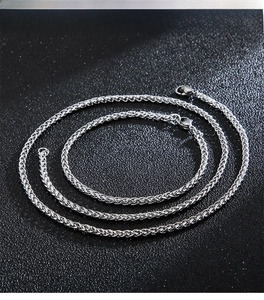 Detailed view of silver braided wheat chain necklaces with secure lobster clasps