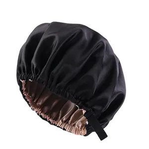 Double-layer satin sleep bonnet with adjustable strap in black and champagne silk fabric