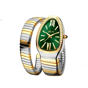 Close-up of luxury snake-head watch dial with emerald green face and crystal accents