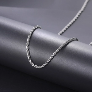 Polished silver stainless steel twist chain necklace for men on a grey pedestal