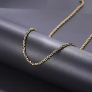 Detailed close-up of 3mm gold and silver twisted rope chain in stainless steel finish