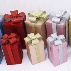 Matte Christmas gift boxes with glitter finish and bows for festive window displays