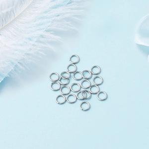 DIY jewelry 304 stainless steel open jump rings on blue background with white feather