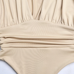 Detail of beige V-neck long sleeve bodysuit with waist pleats and soft elastic fabric