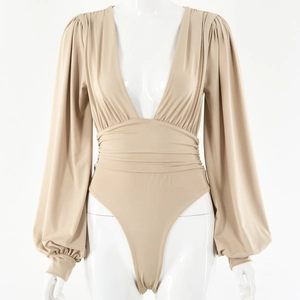 Detail view of beige deep V-neck bodysuit with bishop sleeves and pleated waist design
