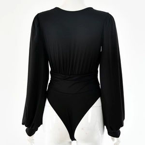 Rear view of black long sleeve bodysuit showing deep V back design and gathered waist details