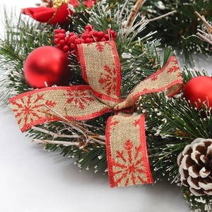 Christmas wreath with red berries, pine cones and snowflake bow on white background