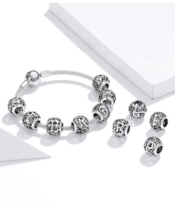 Macro view of S925 sterling silver hollow letter charm with Family Forever engraving
